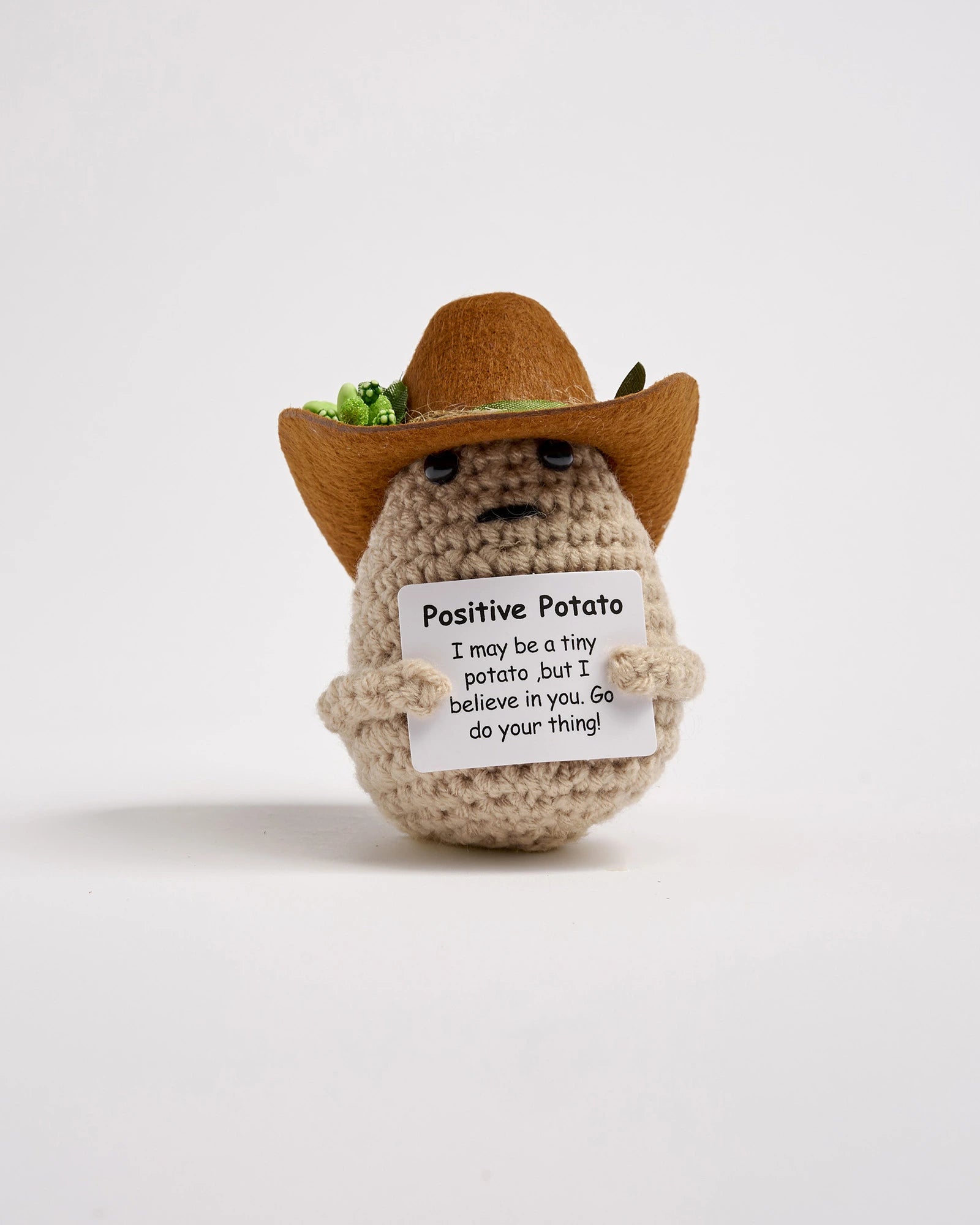 Crochet potato wearing a cowboy hat with a message on a white background
