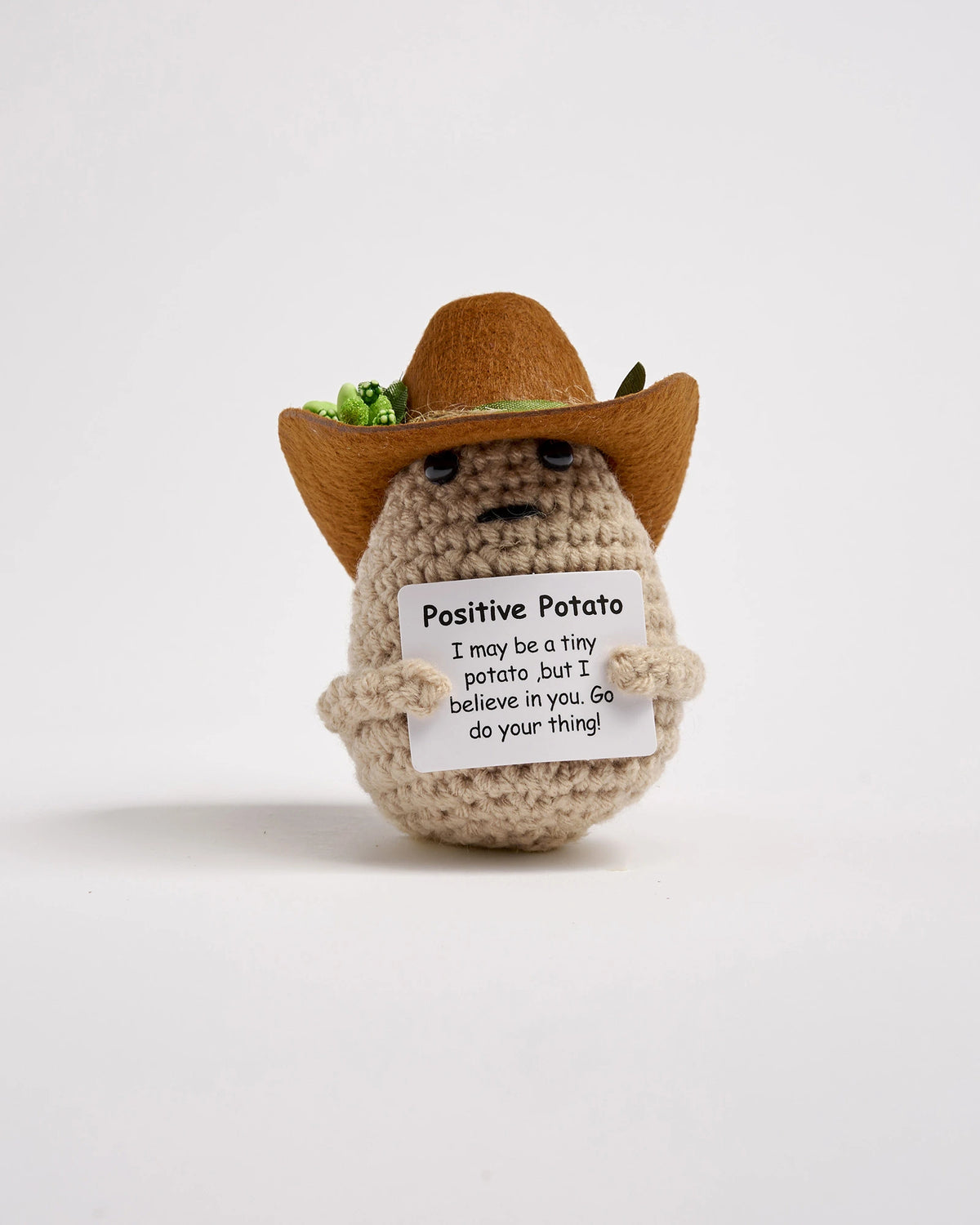 Crochet potato wearing a cowboy hat with a message on a white background